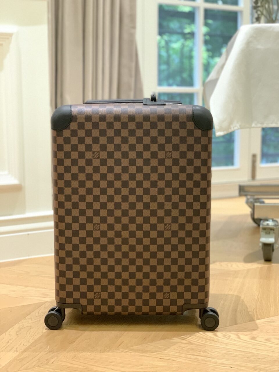 Louis Vuitton Horizon 55 rolling suitcase in Damier Ebene canvas.